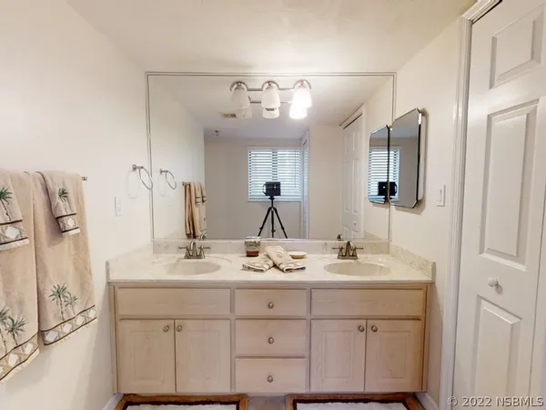 a bathroom with a sink vanity and mirror