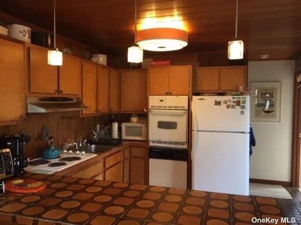 a kitchen with refrigerator and cabinets