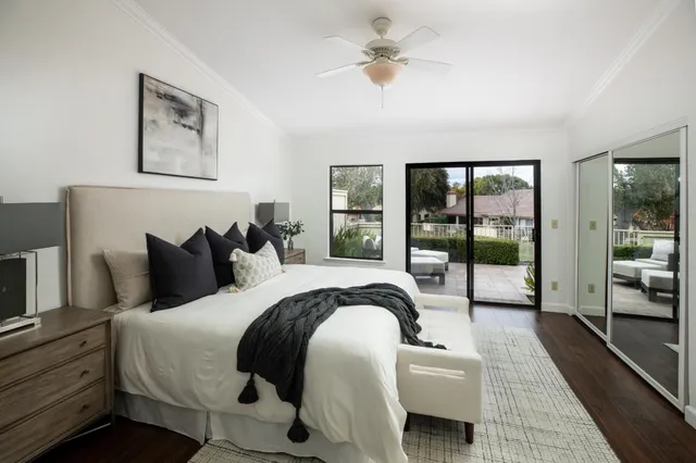 a bedroom with bed and a large window