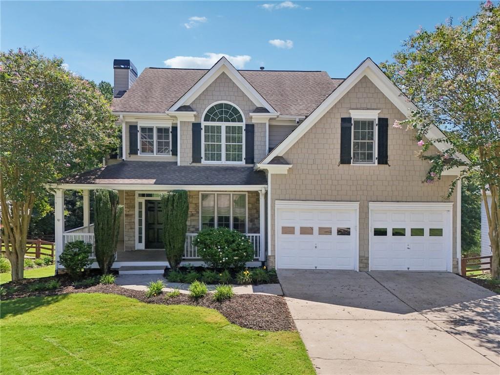 8985 Forest Path Drive Gainesville, GA 30506 - Photo 1 of 1 a front view of a house with a yard and garage