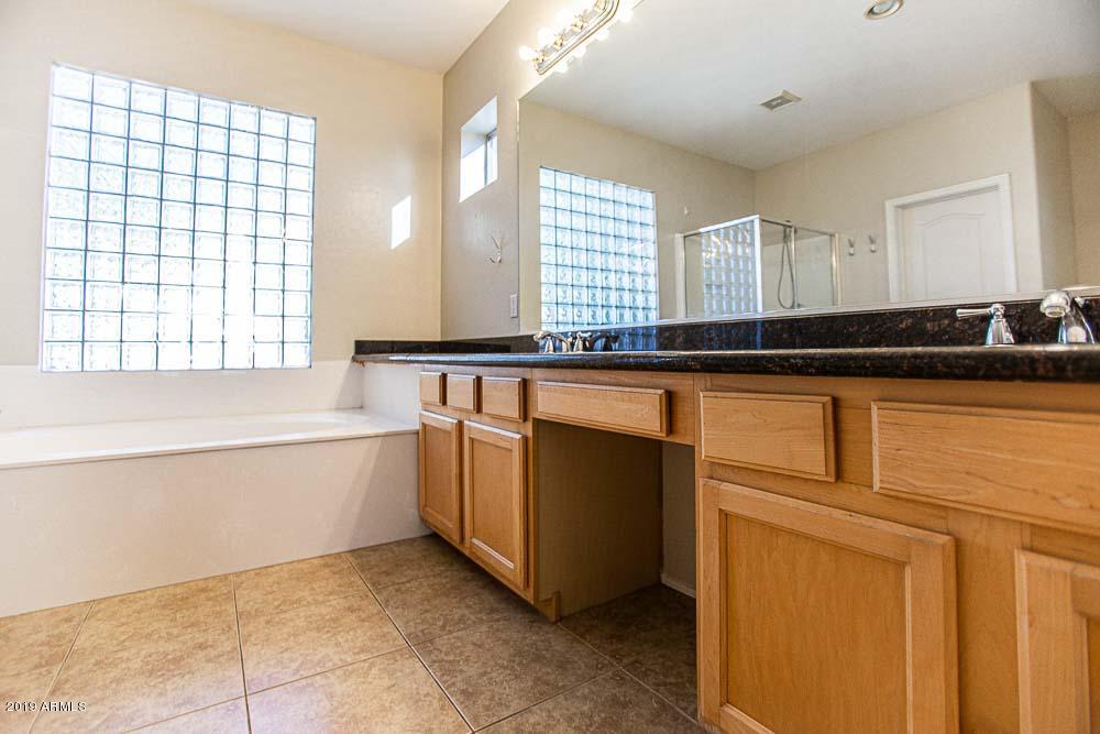 484 East Ranch Road Gilbert, AZ 85296 - Photo 12 of 36 a kitchen with granite countertop white cabinets and white appliances