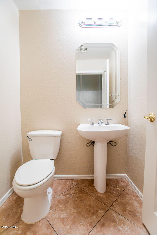 484 East Ranch Road Gilbert, AZ 85296 - Photo 14 of 36 a bathroom with a toilet sink and mirror