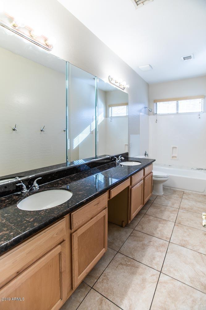 484 East Ranch Road Gilbert, AZ 85296 - Photo 24 of 36 a large bathroom with a granite countertop sink and a mirror