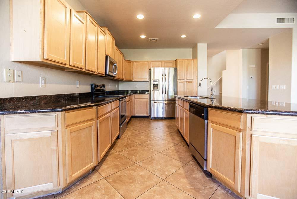 484 East Ranch Road Gilbert, AZ 85296 - Photo 3 of 36 a large kitchen with stainless steel appliances granite countertop a stove a sink and a refrigerator