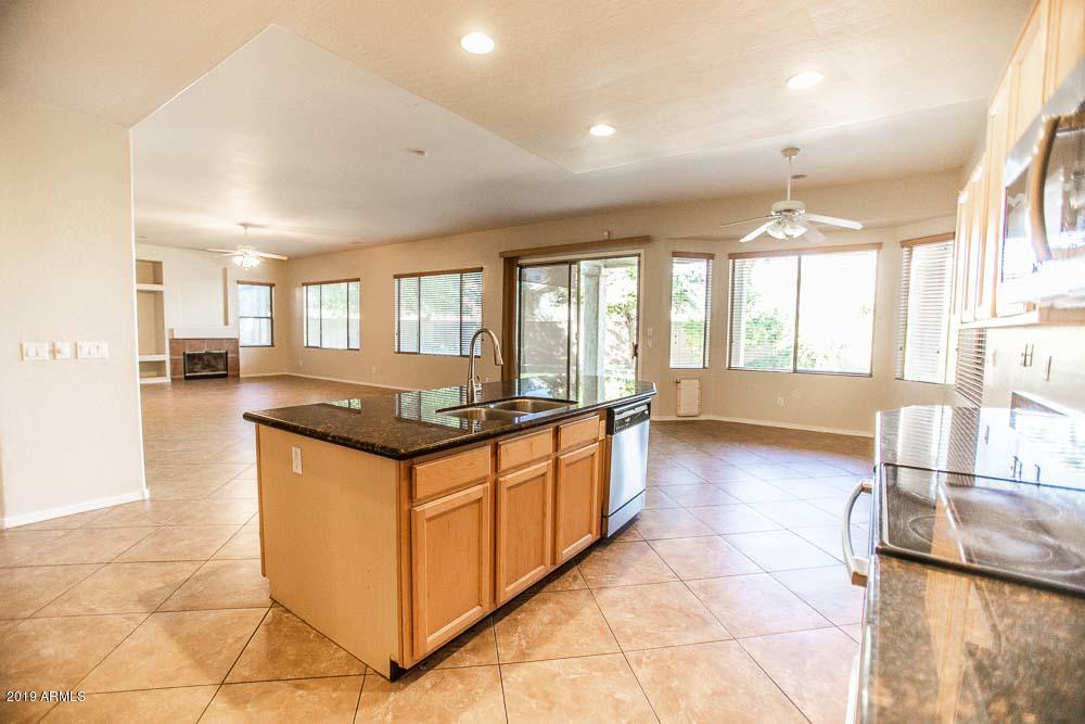 484 East Ranch Road Gilbert, AZ 85296 - Photo 4 of 36 a large kitchen with kitchen island granite countertop a large window and a counter top space