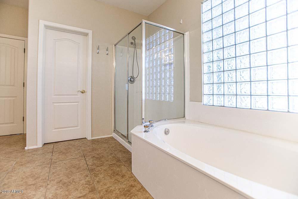 484 East Ranch Road Gilbert, AZ 85296 - Photo 10 of 36 a white bath tub sitting in a bathroom next to a window