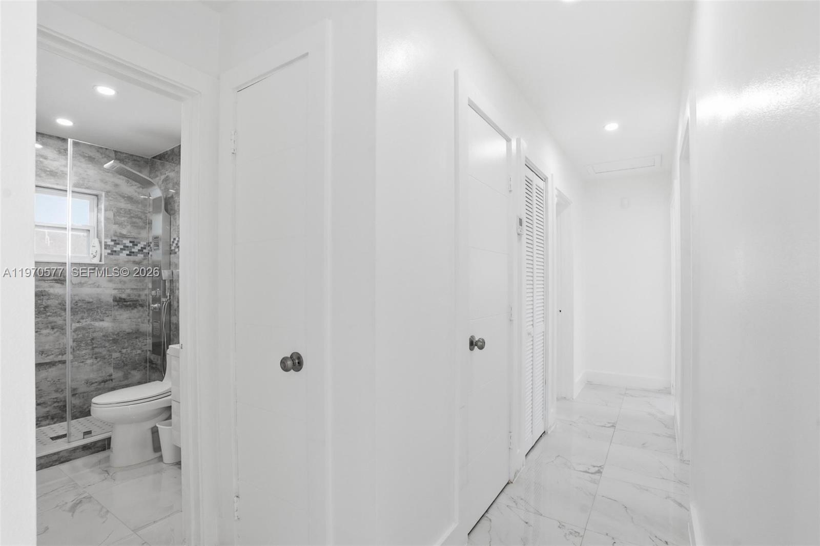 5521 Southwest 104th Avenue Miami, FL 33165 - Photo 13 of 28 a bathroom with a glass shower door