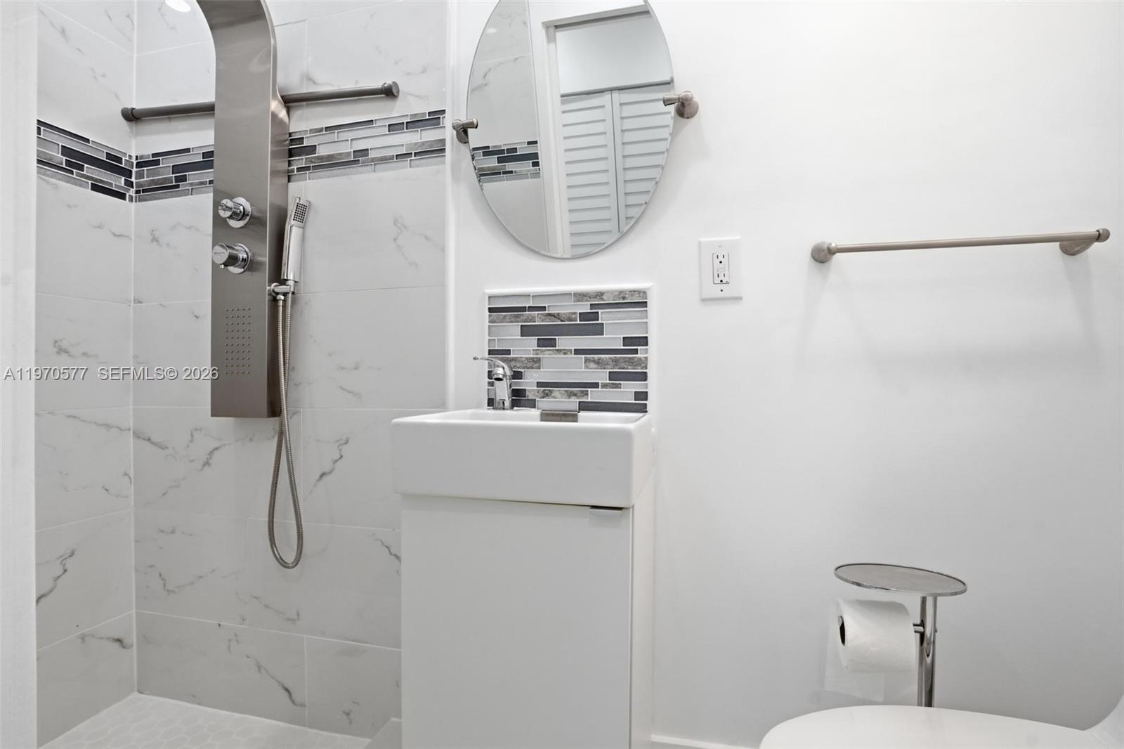 5521 Southwest 104th Avenue Miami, FL 33165 - Photo 21 of 28 a bathroom with a shower a toilet and a mirror