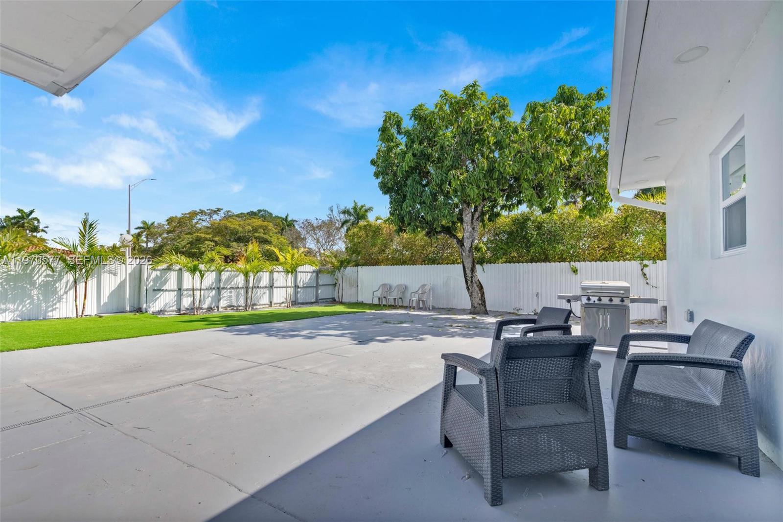 5521 Southwest 104th Avenue Miami, FL 33165 - Photo 23 of 28 a backyard of a house with table and chairs