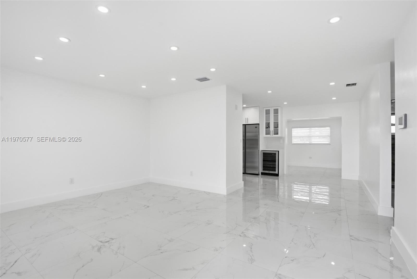 5521 Southwest 104th Avenue Miami, FL 33165 - Photo 5 of 28 an empty room with wooden floor and windows
