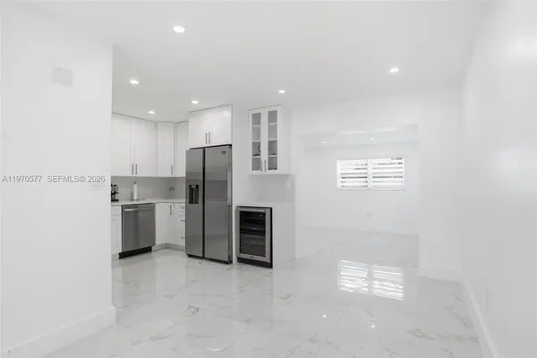 a kitchen with stainless steel appliances a refrigerator and a stove top oven
