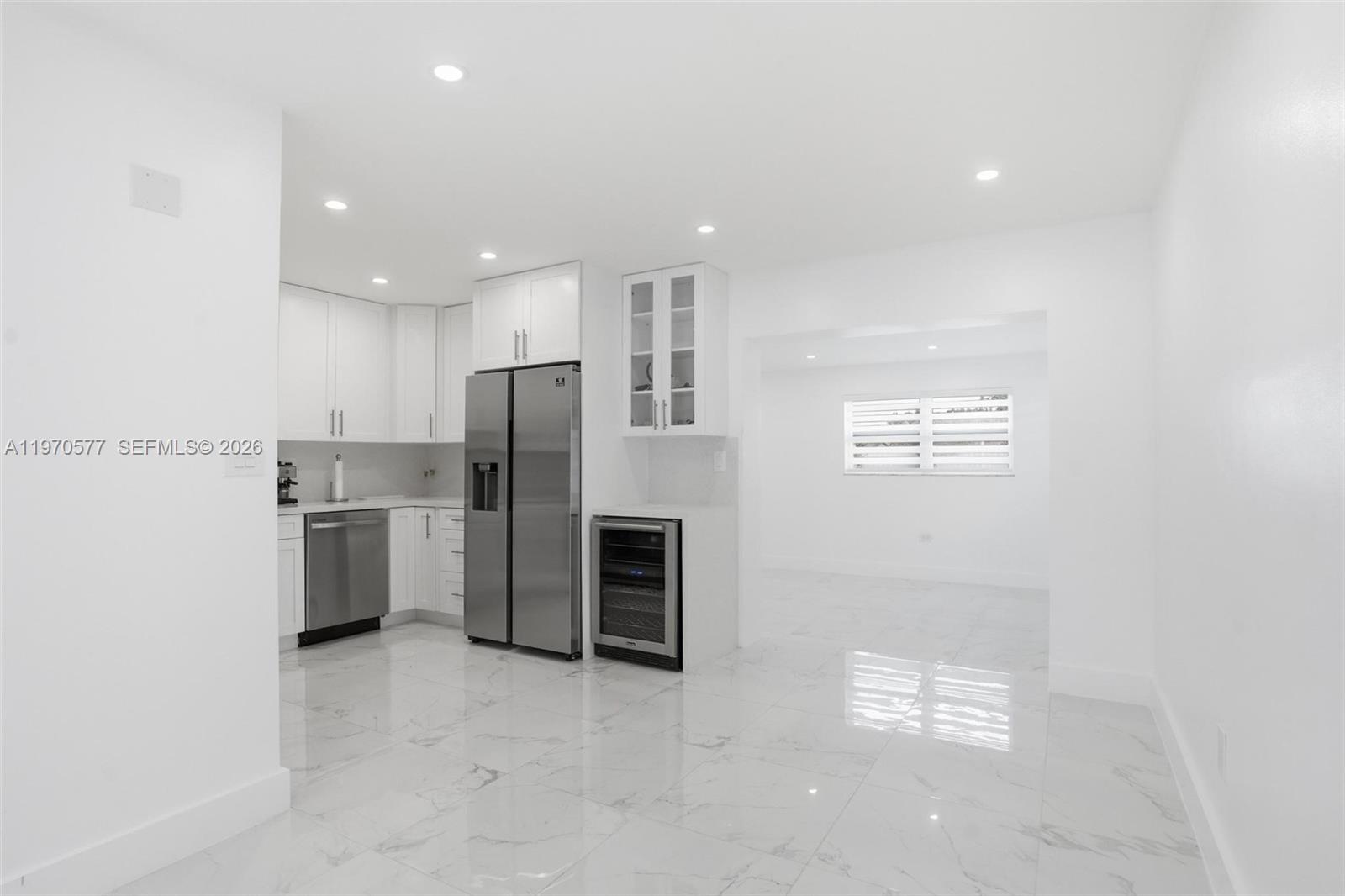 5521 Southwest 104th Avenue Miami, FL 33165 - Photo 9 of 28 a kitchen with stainless steel appliances a refrigerator and a stove top oven