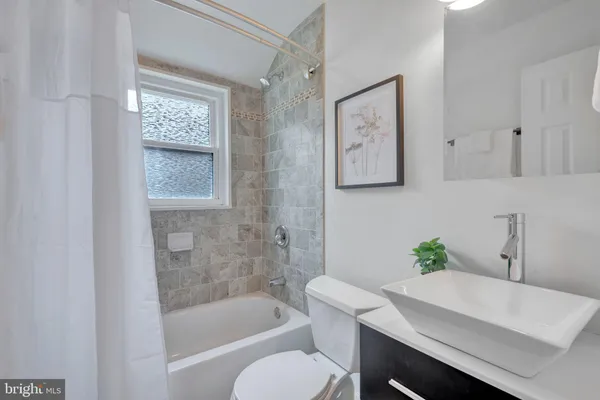 a white bath tub sitting next to a white toilet