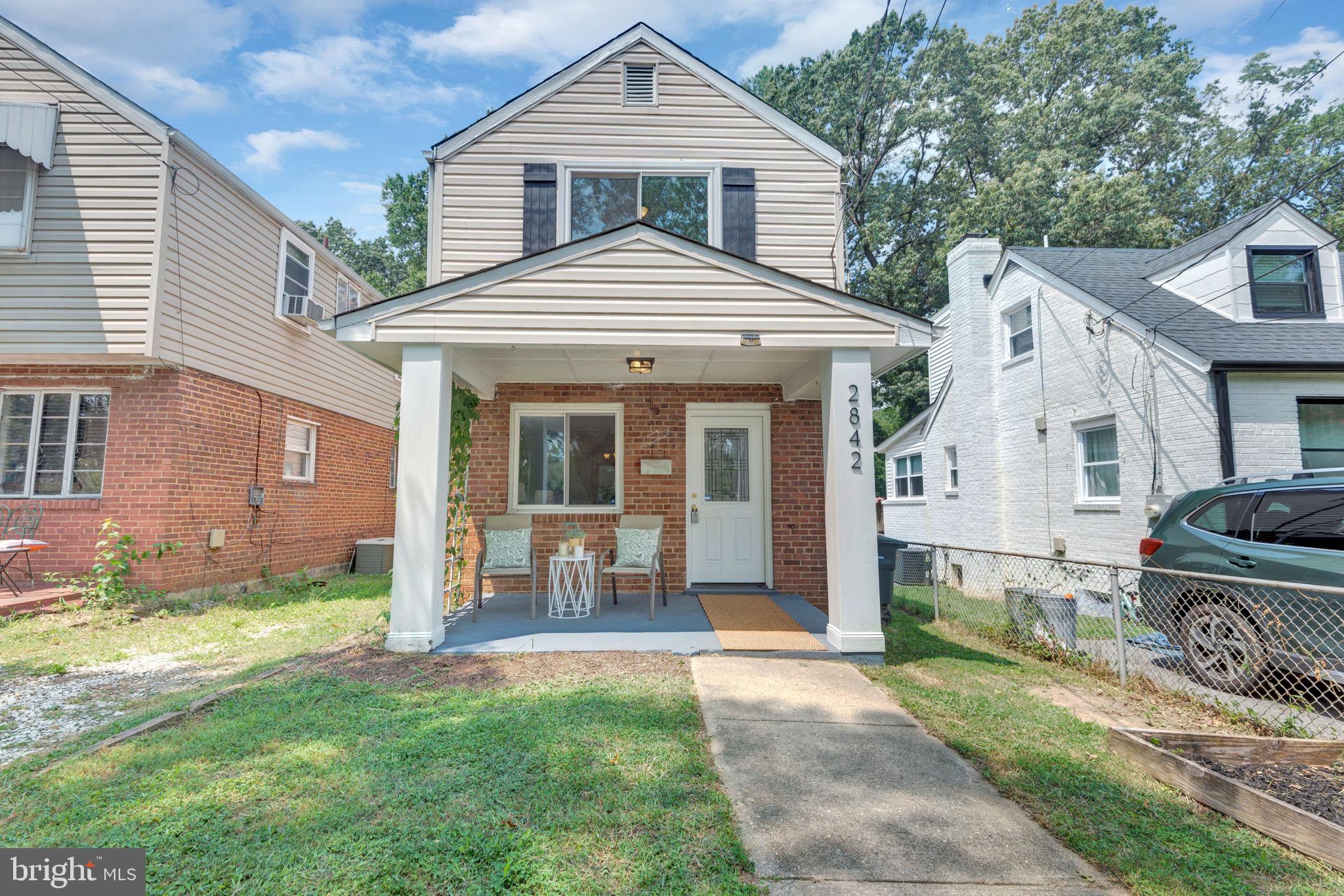 2842 30th Street Northeast Washington, DC 20018 - Photo 17 of 18 a front view of a house with a yard