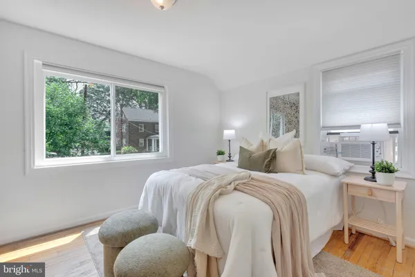 a bedroom with a bed and a large window