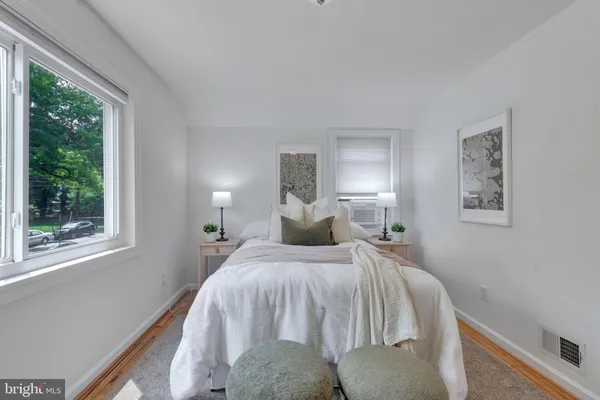 a bedroom with a bed and window