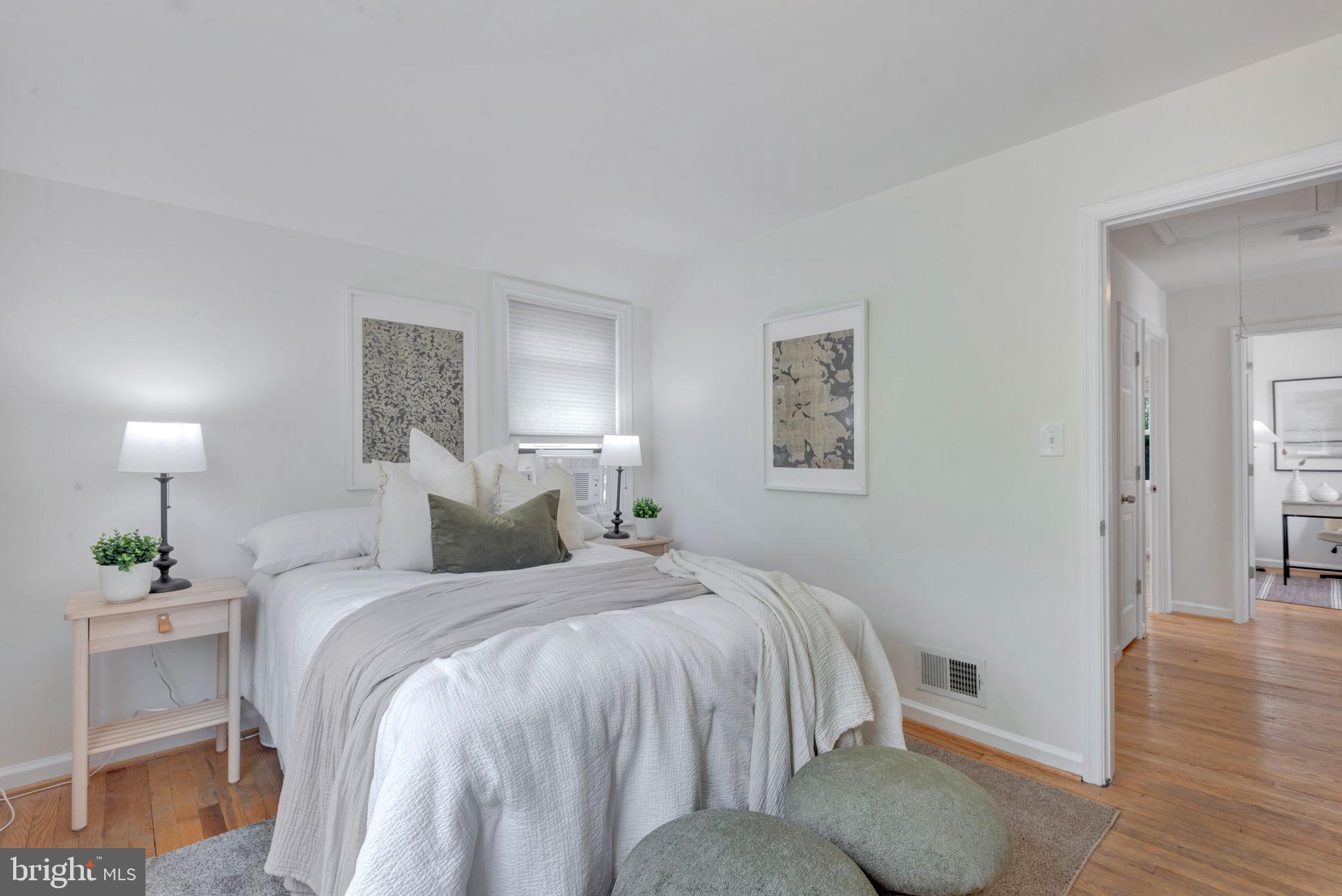 2842 30th Street Northeast Washington, DC 20018 - Photo 9 of 18 a bedroom with a bed and wooden floor