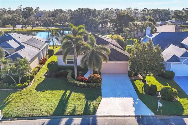 an aerial view of residential houses with outdoor space and swimming pool