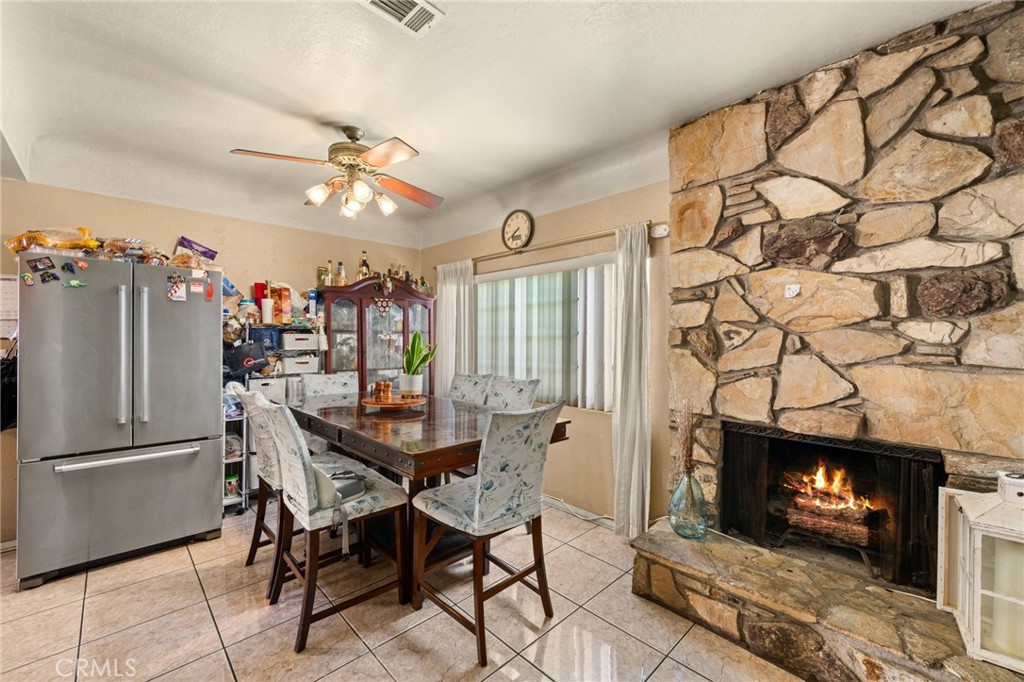 15355 Eucalyptus Avenue Bellflower, CA 90706 - Photo 11 of 20 a view of a dining room with furniture and a fireplace
