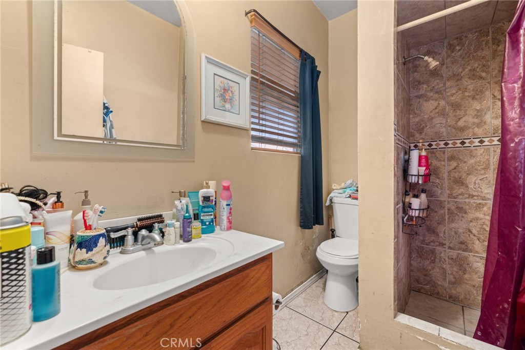 15355 Eucalyptus Avenue Bellflower, CA 90706 - Photo 12 of 20 a bathroom with a sink a toilet and shower