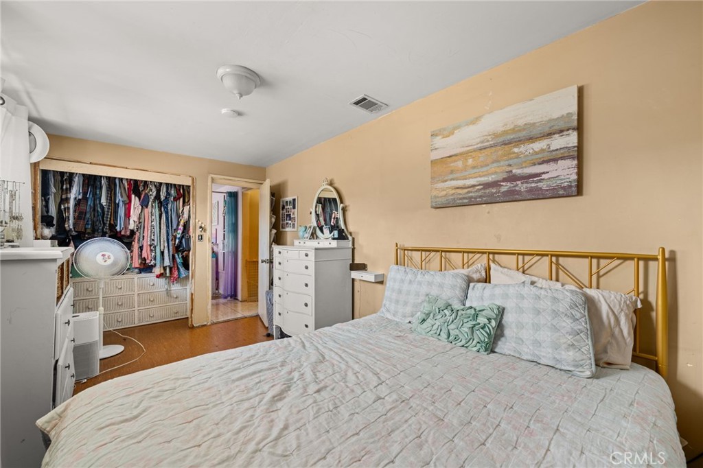15355 Eucalyptus Avenue Bellflower, CA 90706 - Photo 16 of 20 a bedroom with a large bed and a kitchen