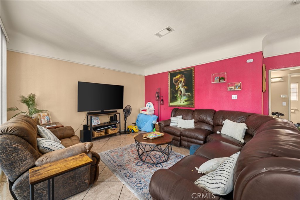 15355 Eucalyptus Avenue Bellflower, CA 90706 - Photo 4 of 20 a living room with furniture and a flat screen tv