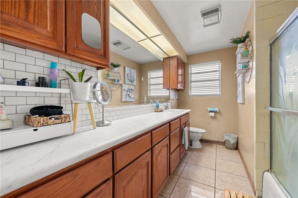 15355 Eucalyptus Avenue Bellflower, CA 90706 - Photo 9 of 20 a kitchen with stainless steel appliances kitchen island granite countertop a sink and a refrigerator