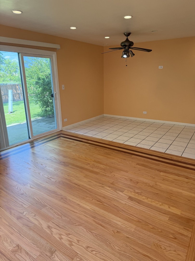 606 Bridgeport Place Wheeling, IL 60090 - Photo 13 of 25 an empty room with wooden floor and windows