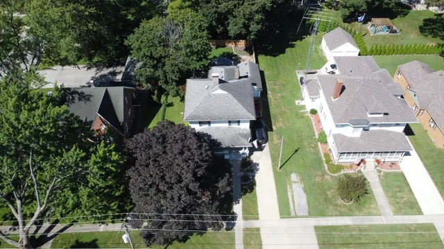 a view of an empty room with a fireplace and wooden floor