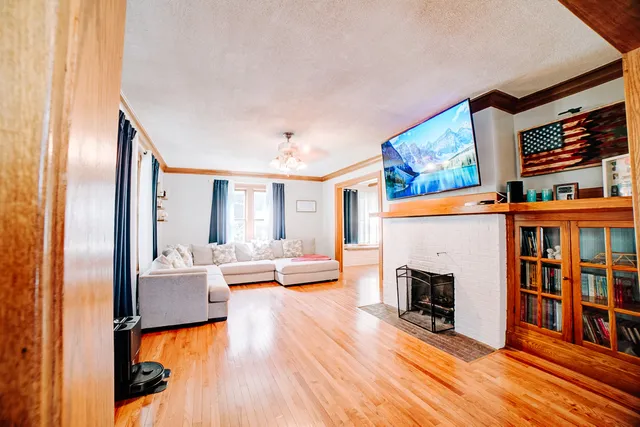 a view of livingroom with furniture fireplace and wooden floor