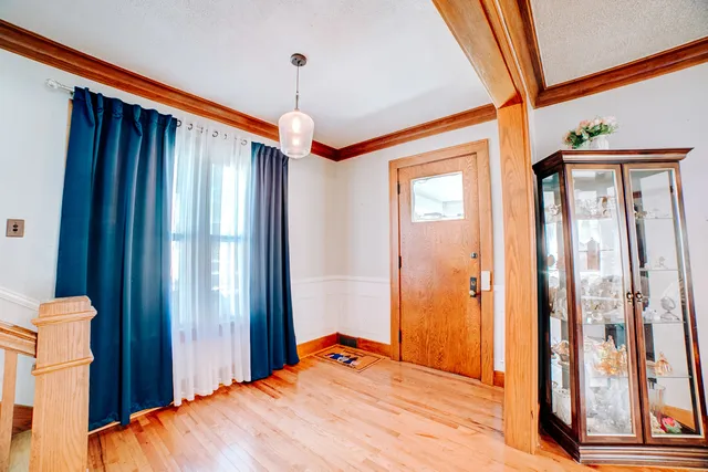 a view of a livingroom with furniture wooden floor a chandelier