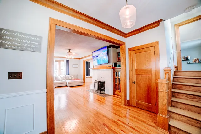 a dining room with furniture and wooden floor