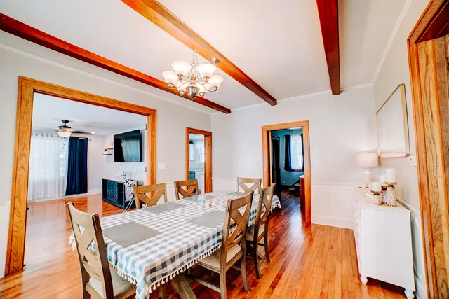 a dining room with furniture and wooden floor