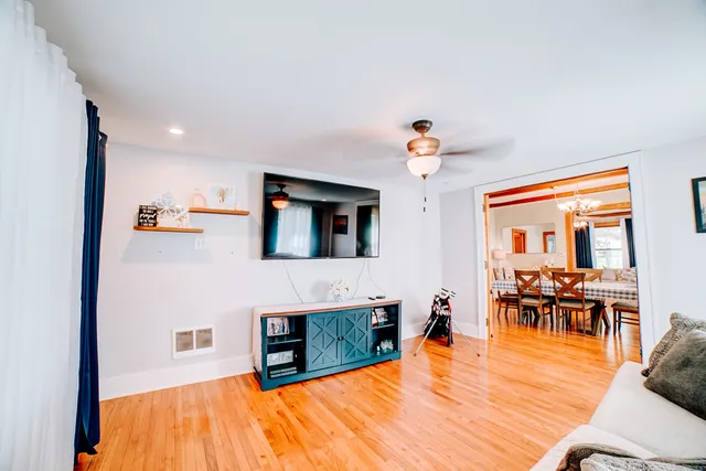 a living room with furniture and a chandelier