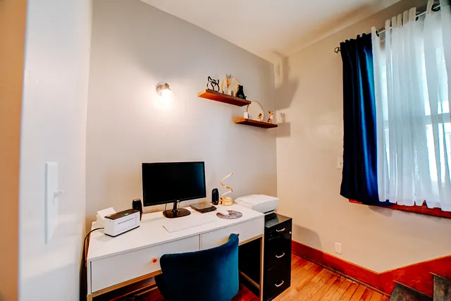 a kitchen with a refrigerator stainless steel appliances wooden floor and cabinets
