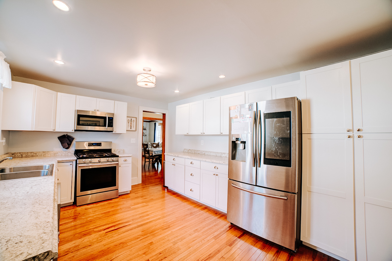 425 South 4th Street Watseka, IL 60970 - Photo 31 of 50 a kitchen with a refrigerator stainless steel appliances wooden floor and cabinets