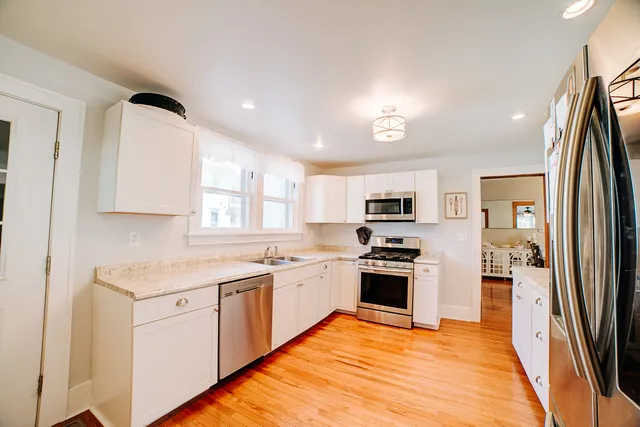 a view of a kitchen with closet and wooden floor