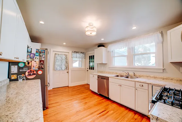 a bedroom with a bed and a large mirror on the dresser