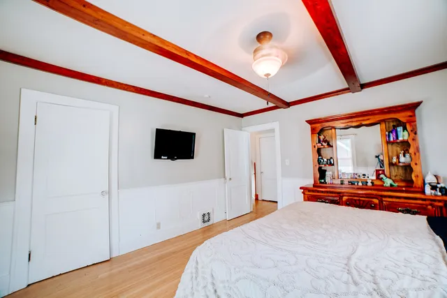 a bedroom with a bed and a chandelier