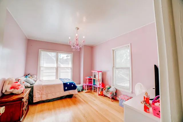 a bedroom with furniture and a wooden floor