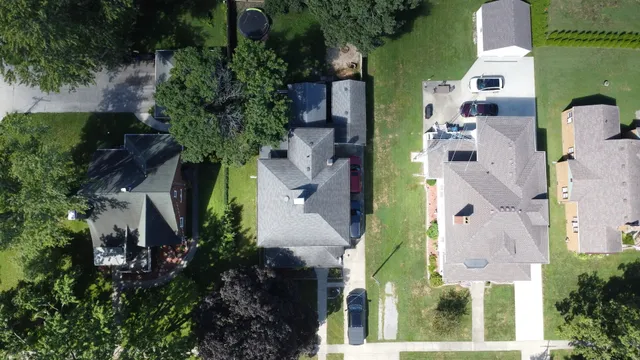 an aerial view of a house with a garden and trees