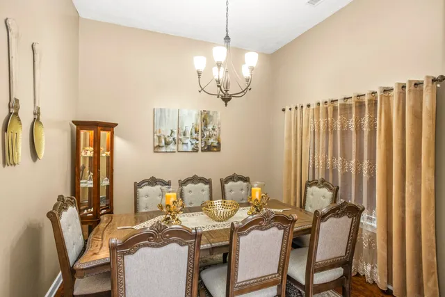 a view of a dining room with furniture and a window