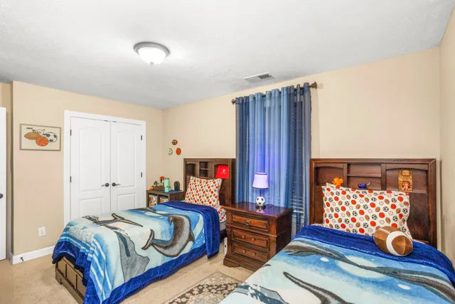 a bedroom with bed and wooden floor