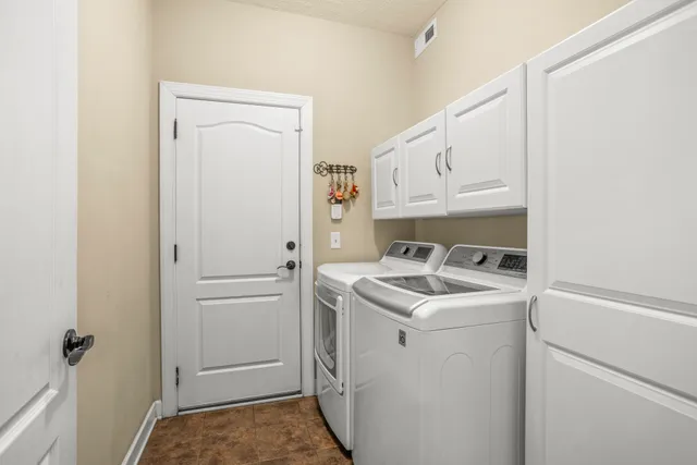 a utility room with closet dryer and washer