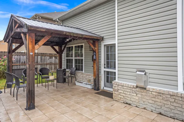 a view of a patio with table and chairs and wooden floor