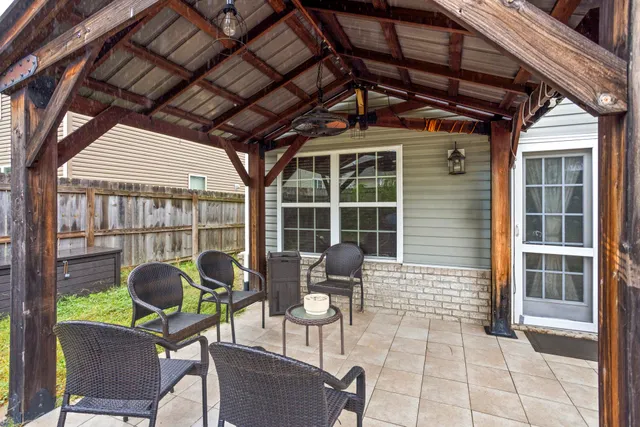 a view of a porch with chairs and a potted plant