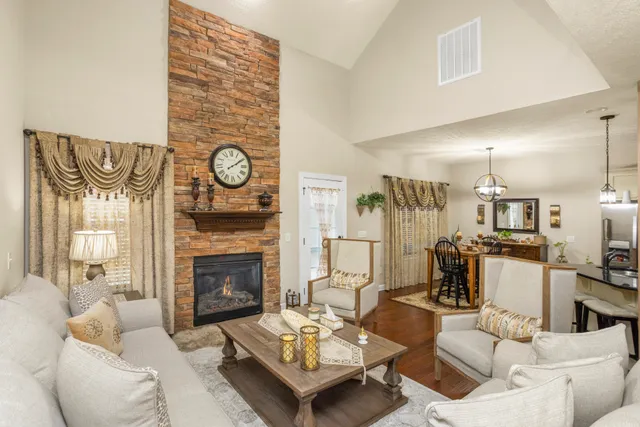 a living room with furniture and a fireplace