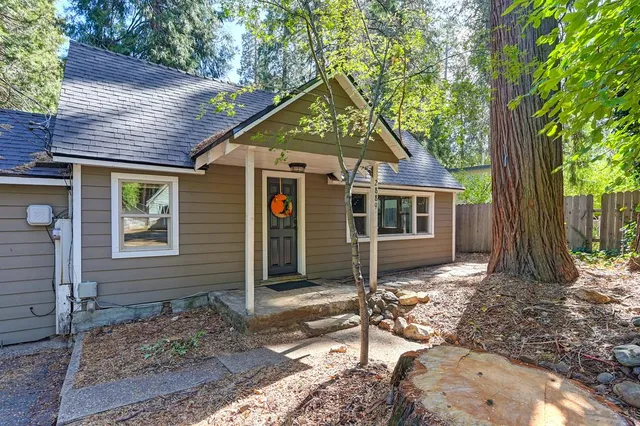 a view of an empty room with glass window and hardwood floor