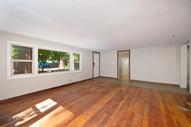a bathroom with a bathtub and mirror