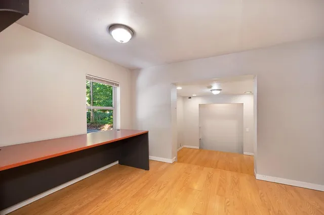 a view of a house with a backyard and trees